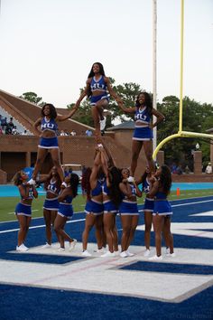 a group of cheerleaders standing on top of each other