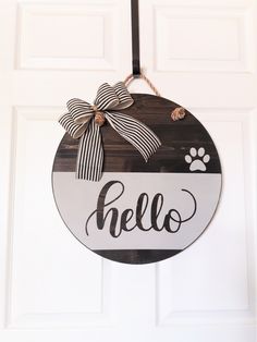 a door hanger that says hello with a dog's paw on it