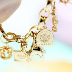 Our mini solid gold Monaco travel charm appeals to jet setters everywhere. This tiny yet deluxe principality features glittering casinos and oversized yachts next to the sparkling Mediterranean Sea. Once you're ashore, just be careful for Formula One racers who might come barrelling down the corniche. Approximate dimensions: 8 x 10 mm Monaco Travel, Travel Charm Bracelet, Solid Gold Charms, Passport Stamps, Travel Charms, Mini Charm, Gold Charm Bracelet, Jet Setter, Rainbow Earrings