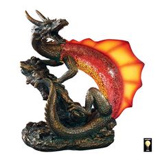 a dragon figurine with an orange flame coming out of it's mouth