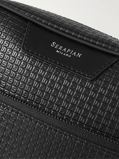 Serapian's 'North South' messenger bag has been made in Italy from water-resistant 'Stepan' coated-canvas trimmed with tactile leather. It has an adjustable strap to sit comfortably on your shoulder and a zipped front pocket to keep small essentials organised. Business Shoulder Bag With Embossed Logo Crossbody, Business Crossbody Bag With Embossed Logo, Black Shoulder Bag With Embossed Logo For Travel, Black Travel Shoulder Bag With Embossed Logo, Black Bags With Embossed Logo For Formal Occasions, Black Formal Bag With Embossed Logo, Classic Travel Shoulder Bag With Embossed Logo, Black Formal Bags With Embossed Logo, Modern Travel Shoulder Bag With Embossed Logo