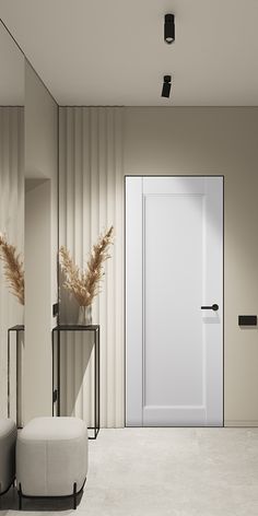 an empty room with a white door and two stools in front of the door