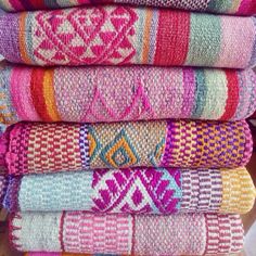 several colorful towels stacked on top of each other