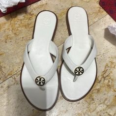 Beautiful Sandals For Tory Burch ,New I Only Tried It In The Store Comes With The Box , Ivory Color With Gold . My House Pet Free Smoke Free Luxury White Sandals With Single Toe Strap, White Classic Sandals With Single Toe Strap, Classic White Sandals With Single Toe Strap, Classic White Flat Sandals, White Leather Toe Post Sandals, White Flip Flops With Single Toe Strap, Classic White Sandals For Vacation, Classic White Slip-on Sandals, Designer White Sandals With Cushioned Footbed