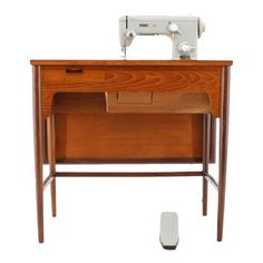 a sewing machine sitting on top of a wooden table