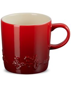 a red coffee cup with white rims