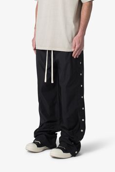 the Side Snap Nylon Pants are designed in an oversized fit, constructed from a custom developed nylon fabric with lining, contrast drawcord, welt pockets at the side seam, and finished with snap details up the outseam. details baggy fit throughout 100% nylon snap details model is 6’1, 140 lbs and wears a size 30