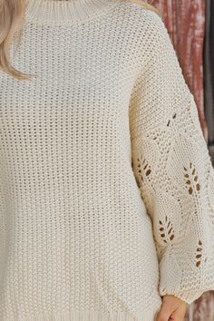 This Crochet Sleeve Pullover Sweater in Cream offers a chic blend of texture and style! Featuring long balloon sleeves with intricate crochet detailing, this sweater adds a unique flair to any outfit. It has a round neckline with ribbed detailing at the neckline, cuffs, and hem, enhancing its cozy feel. Designed with an oversized fit, it's perfect for layering and everyday comfort. Style with jeans, ankle booties, and a wide brim hat for an elevated chic outfit. Oversized Open Knit Crochet Top For Fall, Winter Pointelle Knit Sweater With Puff Sleeves, Winter Puff Sleeve Pointelle Knit Sweater, Chic Fall Crochet Top With Open Knit, Winter Knit Top With Puff Sleeves, Chic Crochet Top With Open Knit For Fall, Chic Open Knit Crochet Top For Fall, Knit Lantern Sleeve Sweater For Spring, Fall Textured Knit Top With Puff Sleeves