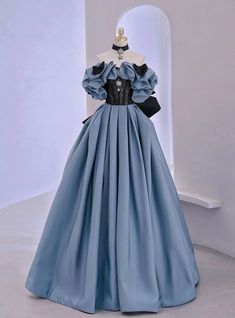 Forging an unforgettable presence, this prom dress is a testament to the fusion of classic elegance and modern couture. The dress features a majestic steel blue hue, accented with a dramatic black lace bodice that intricately weaves sophistication with allure. Voluminous puff sleeves and a sweeping full skirt create a silhouette reminiscent of regal ballgowns, while the stark contrast of colors injects a contemporary edge. This gown, complete with a cinched waist and delicate lace detailing, stands as a unique piece for those seeking to make a bold statement at prom.Silhouette:a-lineHemline:floor lengthNeckline:off the shoulderFabric:satinShown Color:blueSleeve Style:sleevelessBack Style:lace upEmbellishment:lace bowBuilt-in Bra: yes Prom Dress Off Shoulder, डिजाइनर कपड़े, Lace Long Prom Dress, Off Shoulder Evening Dress, Old Fashion Dresses, Dress Off Shoulder, Blue Evening Dresses, فستان سهرة, Fairytale Dress