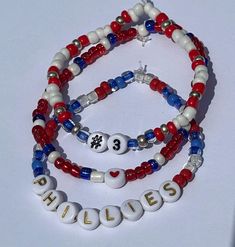 Acknowledge your love for the Phillies and MV3 Bryce Harper with this bracelet set. The size and player number can be personalized!  Please read our policies below before purchasing and don't hesitate to contact us with any questions you may have.  Go Phils! *BEAD TYPE: Glass Beads on Elastic .7mm Cord *PROCESSING TIME: Our current processing time is 4-6 business days.  Processing is the time needed to prepare your order for shipment and is NOT the amount of time it will take your order to be delivered to you. *SHIPPING: Orders are shipped via USPS first class with tracking.  WE ARE NOT RESPONSIBLE FOR USPS DELAYS OR LOST/DAMAGED PACKAGES.  We do not issue refunds for these circumstances.  Should any of these situations occur, a claim needs to be placed by the buyer. *CARE INSTRUCTIONS: Do Adjustable Red Name Bracelet With Round Beads, Red Beaded Name Bracelet With Round Beads, Red Beaded Name Bracelet, Personalized Red Wristband With Round Beads, Baseball Bracelet, Bryce Harper, Seed Bead Bracelet, Glass Bracelet, Seed Bead Bracelets