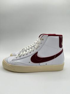 Step up your sneaker game with these Nike Blazer Mid 77 SE sneakers in the Sisterhood colorway, featuring a clean white leather upper with pops of Team Red and Muslin accents. The mid-top shoe shaft style gives a classic look that will never go out of style, while the athletic design is perfect for any activity. Made by the trusted brand Nike, these sneakers are sure to be a great addition to any collection. With a UK shoe size of 4, US size of 6.5, and EU size of 37.5, these shoes are designed for women who love style and comfort. The model number is DV7003-100 and the style code is perfect for those who want to stand out. Get your hands on these Nike Team shoes today! Nike Retro White Custom Sneakers, Nike Retro Custom White Sneakers, Nike White High-top Sneakers With Gum Sole, Retro Nike Custom White Sneakers, Retro White High-top Sneakers With Rubber Sole, Retro Mid-top Sneakers With Red Sole, Red High-top Sneakers With Perforated Toe Box, White Leather High-top Sneakers With Gum Sole, Retro White Basketball Shoes With Contrast Sole