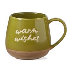 a green mug with the words warm wishes written on it