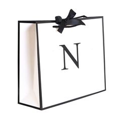 a black and white shopping bag with the letter n on it's front side