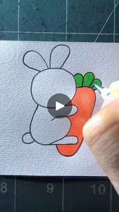 someone is drawing a cartoon carrot on paper