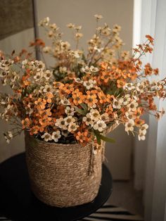 a basket filled with flowers sitting on top of a table