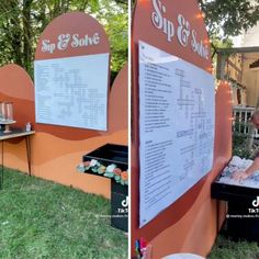 a man standing in front of a sign next to a table with food on it