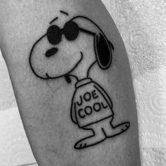 a black and white photo of a dog with sunglasses on it's head, wearing a shirt that says joe cool