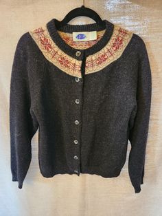 This is a lovely Vintage Spin Button Front Cardigan Sz L. Made of 100% Shetland wool and it features and round collar, ribbed collar, cuffs and hem. It has been gently worn and is in excellent condition. Measurements Length 22" Shoulders 18" Sleeves 24" Bust 44" Classic Fall Outerwear With Fair Isle Pattern, Winter Sweater With Button Cuffs, Classic Fair Isle Pattern Outerwear For Fall, Classic Fair Isle Outerwear For Fall, Wool Sweater With Button Cuffs For Winter, Winter Wool Sweater With Button Cuffs, Winter Button-up Sweater With Ribbed Cuffs, Winter Crew Neck Sweater With Button Closure, Vintage Winter Sweater With Ribbed Cuffs