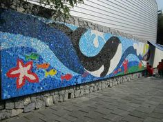 a mosaic mural on the side of a building