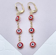 "Christmas season is a great period to give gifts. Enjoy a special collection just having you in mind. It's time to celebrate. Time to give, time to receive. Time to spread love. 18k Gold Filled Red Evil Eye Dangling Earring Our Etsy store was developed to help you find the most unique styles of modern designs, always looking for elegance and market trends. Here you will find ways to better make your jewelry through quality, seeking harmony, exclusivity and impeccable finish. Find many more styl Cheap Red Evil Eye Jewelry, Red Jewelry For Pierced Ears As A Gift, Red Round Earrings For Christmas, Red Ear Wire Jewelry For Holidays, Red Hypoallergenic Jewelry For Party, Red Hypoallergenic Party Jewelry, Hypoallergenic Red Jewelry For Parties, Nickel Free Red Jewelry As Gift, Nickel Free Red Jewelry Gift