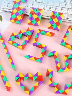 colorful origami pieces sitting on top of a computer keyboard