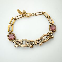 Unique one-of-a-kind Art Deco era link bracelet featuring vintage repurposed gold filled and gold filled over sterling links - two have a pink rhinestone accent.  The closure is a gold filled lobster claw design with jump ring on the opposite end along with a gold filled bead accent.  This bracelet looks fabulous on - perfect gift for the woman who loves unique jewelry that nobody else will be wearing.  I can add a couple more jump rings to the end if you need some extra length; simply contact me to discuss. Details *Measures 7 1/4" length x 3/8" across *Combination of gold filled and gold filled over sterling vintage links *Pink rhinestone accents *Gold filled closure *Bracelet weighs 10.8 grams *Ready to ship and sent in a gift box Condition:  All elements are authentic vintage in very g Luxury Vintage Gold Bracelet As Gift, Luxury Vintage Bracelets With Gold Clasp, Luxury Vintage Handmade Bracelets, Heirloom Style Gold Metal Bracelet, Vintage Jewelry With Rectangular Links For Gift, Vintage Yellow Gold Bracelet With Rectangular Links, Heirloom Style Gold Bracelets With Jewels, Heirloom Gold Bracelets With Jewels, Elegant Antique Gold Brass Bracelet