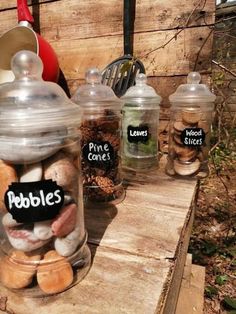 jars filled with different types of food sitting on top of a wooden table