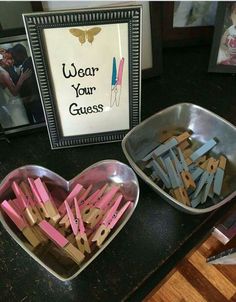 two bowls filled with clothes pins next to a sign that says wear your guess