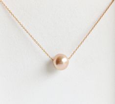 This simple yet elegant necklace is make with Edison pearl. Metallic pink pearl floating gorgeously on a delicate 14k gold filled cable chain. Edison pearl is about 9-10mm in sizes. 14k gold filled spring ring clasp. PLEASE NOTE: As you can see in the photos there are natural occurring blemishes and variation that give these pearls character. These are stock photos so please note pearls are vary in shape and color due to availability. Rose Gold Akoya Pearl Necklace Gift, Rose Gold Akoya Pearl Necklaces With Pearl Drop, Rose Gold Akoya Pearl Drop Necklace, Dainty Rose Gold Pearl Necklace For Formal Occasions, Pink Akoya Pearl Necklaces For Wedding, Pink Akoya Pearl Wedding Necklaces, Rose Gold Akoya Pearl Necklace With Pearl Drop, Pink Akoya Pearl Wedding Necklace, Delicate Rose Gold Pearl Necklace For Formal Occasions