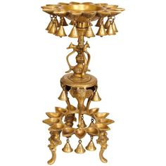 an ornate brass candle holder with bells on it