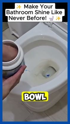 a person is holding a paintbrush over a toilet bowl with the lid open and water in it