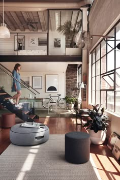 a living room filled with furniture and lots of windows on top of a wooden floor