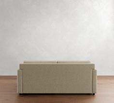 a couch sitting on top of a hard wood floor