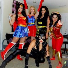 four women dressed in costumes posing for the camera