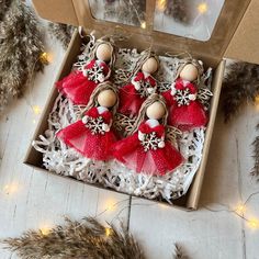 three red and white ornaments in a box