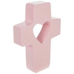 a pink cross shaped object with a heart on the front and bottom part, against a white background