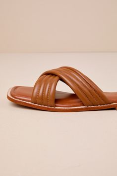 The Rag & Co Eura Tan Leather Slide Sandals will make you more than ready for sunshine and plenty of compliments! Smooth genuine leather shapes these chic sandals that feature a trendy square-toe bed and wide, crisscrossing vamp straps that boast a quilted-like effect. The simple slide-on design makes getting dressed easy and effortlessly cute! Available in whole sizes only. 0. 5" rubber heel. Cushioned insole. Rubber sole has nonskid markings. Genuine leather upper. Balance man made materials. Trendy Brown Sandals With Square Toe, Chic Brown Cross Strap Sandals, Trendy Brown Square Toe Sandals, Leather Sandals With Padded Heel And Cross Strap, Beach Sandals With Square Toe, Brown Beach Sandals With Padded Heel, Brown Padded Heel Sandals For Beach, Chic Cross Strap Sandals For Vacation, Brown Cross Strap Sandals For Spring