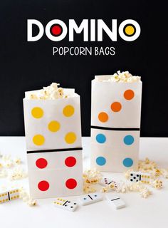 two popcorn bags with different colored dots on them and the words domino written in white