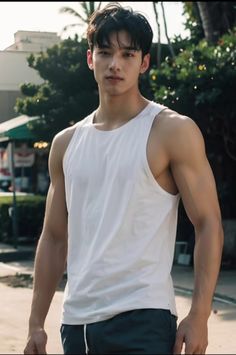 a young man is standing on the street