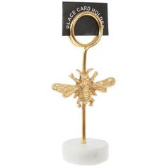 a gold plated card holder with a bee on it