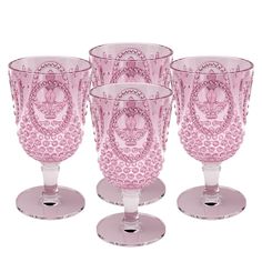 four pink glass goblets sitting on top of each other