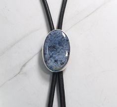 "Versatile Bolo Tie: This is a beautiful sterling silver bolo tie that features a rather rare stone known as Blue Dumortierite. This stone was discovered in the French Alps back in the late 1800s. Its name comes from the man who discovered it ~ Eugène Dumortier. The blue color is very close to denim and can be worn for a formal event or for going out casually. Handcrafted with solid sterling silver components it is the perfect accessory for any special occasion or even to just add to your bolo c Bling Things, Bolo Necklace, Bolo Ties, Rare Stone, French Alps, Bolo Tie, Rhinestone Heart, Perfect Gift For Him, Purple Glass