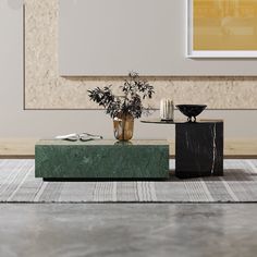 a vase with some flowers on top of a table in front of a painting and candlesticks