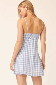 Gingham plaid mini sundress. Sweetheart neckline with pleated detail. Fitted bodice. Sleeveless with adjustable cami straps. Low back with elastic. Invisible zipper side closure. Thigh length. Fit and flare silhouette. 75% Polyester, 20% Cotton, 5% Linen. Imported. Designed in LA. Model wears size S. Meet Cute, Mini Sundress, Fitted Bodice, Invisible Zipper, Low Back, Sweetheart Neckline, Fit And Flare, Sundress, Gingham