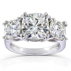 three stone diamond ring in white gold with diamonds around the band and sidestones on each side