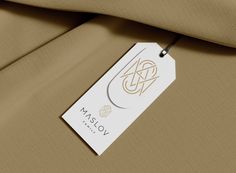 a label on the back of a tan suit with a white tag attached to it