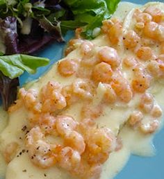 the meal is prepared and ready to be eaten on the blue plate with salad in the background