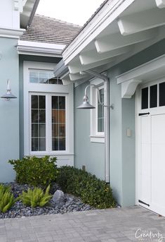 a blue house with white trim on the windows and doors is pictured in this image