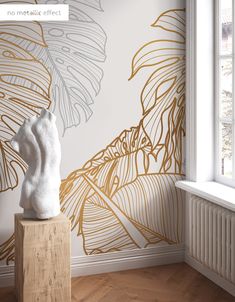 a white statue sitting on top of a wooden block in front of a wall mural