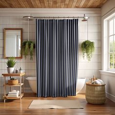 a bath room with a shower curtain and a rug in front of the tub area